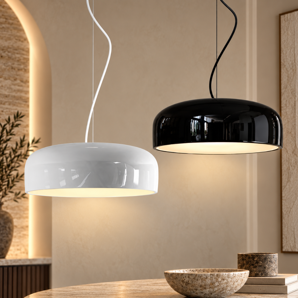 Aluminum Chic Round Pendant Lamp in white and black, two glossy dome pendants lit above a stone table in a warm modern interior