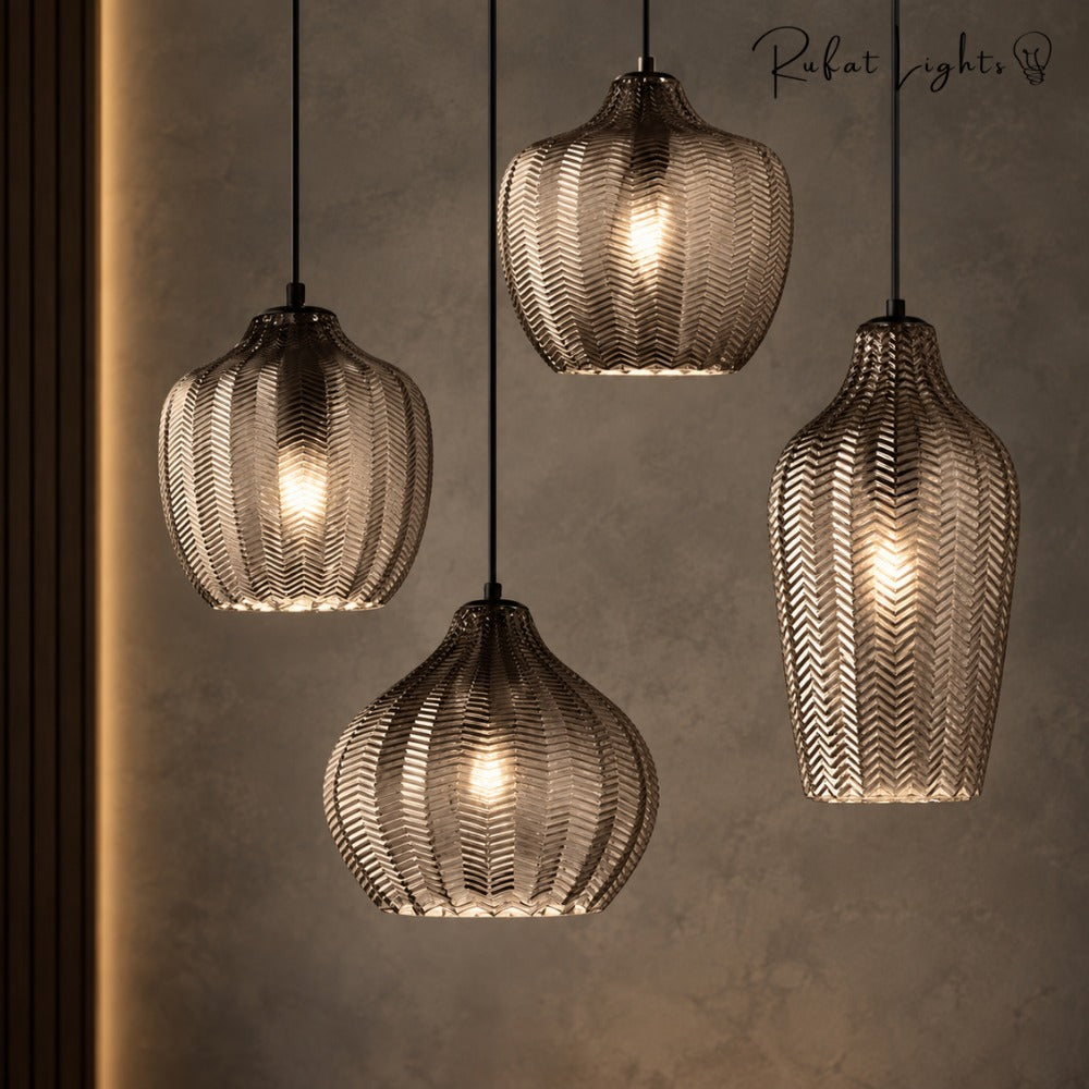 Contemporary Zigzag Glass Pendant Light in grey smoked glass, four shapes against a textured stone wall