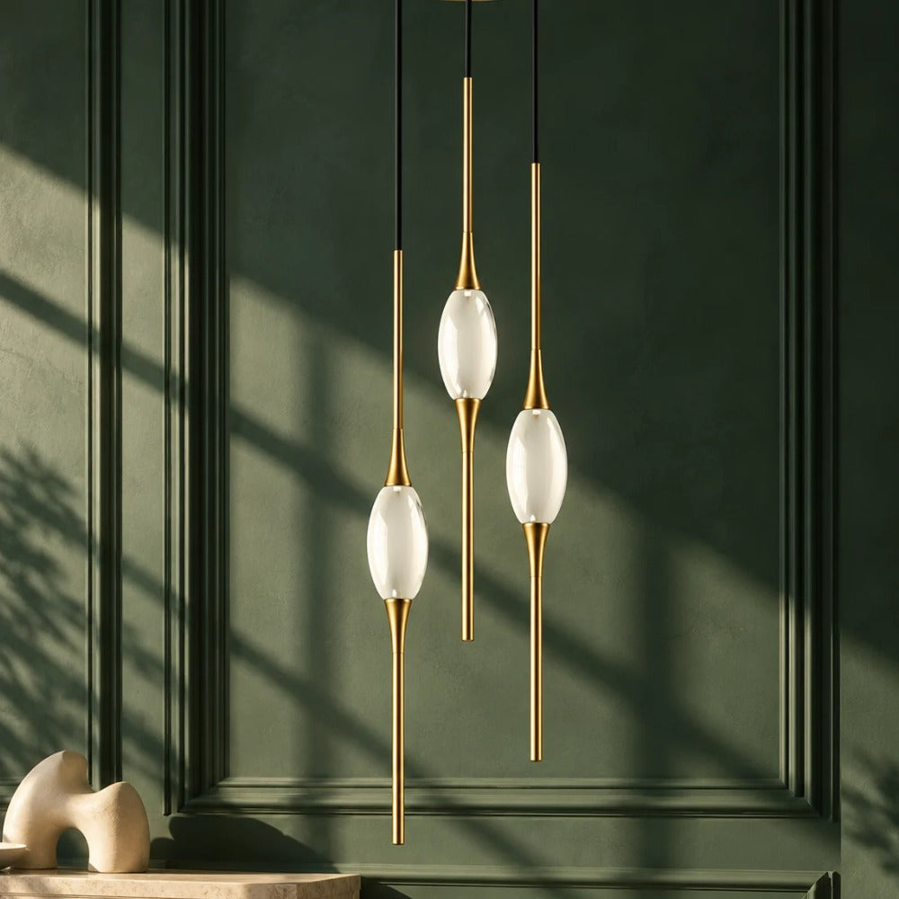 Copper Crystal Pendant Lamp Gold pendants glowing against a green wall