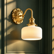 Copper Wandlamp Sconce Glass Wall Light gold wall sconce with white ribbed glass shade glowing against a dark green panelled wall