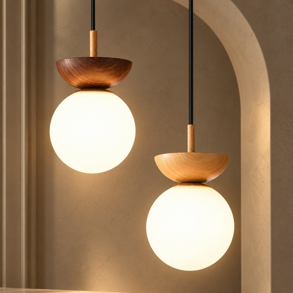 Crystal Sphere Veranda Hanging Light Fixtures pendants in dark wood and light wood with glowing white glass globes against an arched plaster wall