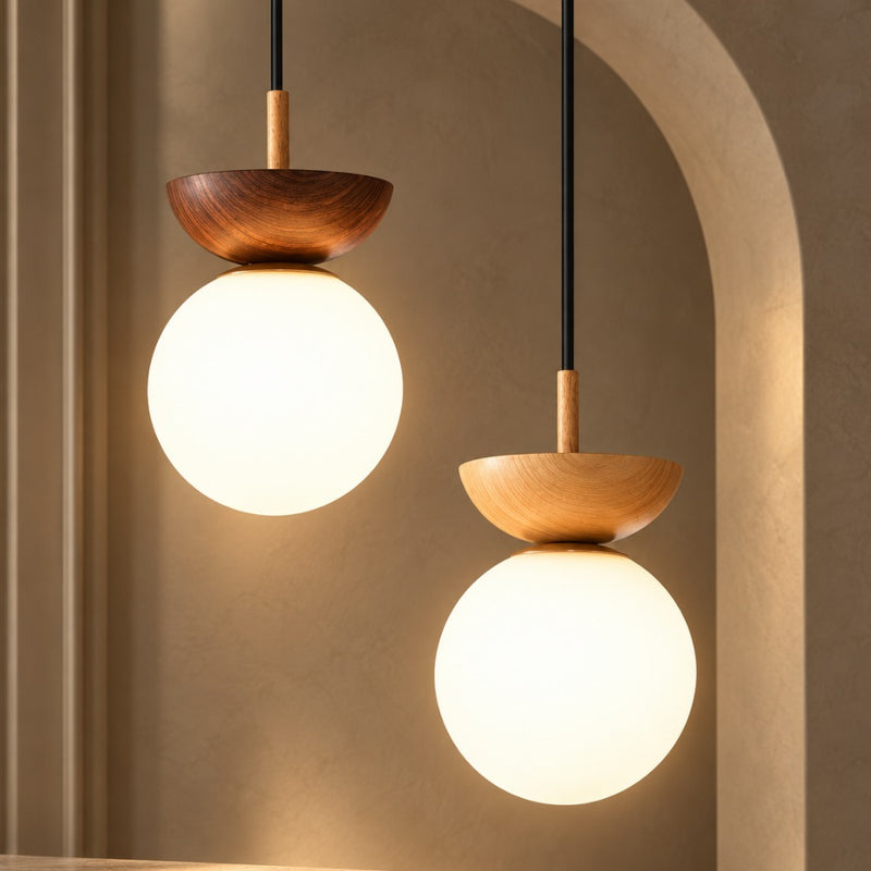 Crystal Sphere Veranda Hanging Light Fixtures pendants in dark wood and light wood with glowing white glass globes against an arched plaster wall