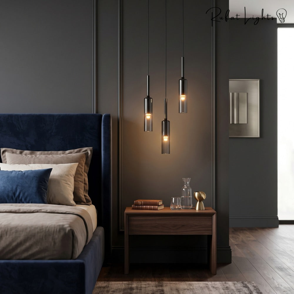 Modern Cylindrical Glass Pendant Light trio beside a bed