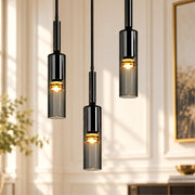 Modern Cylindrical Glass Pendant Light trio against a light wall