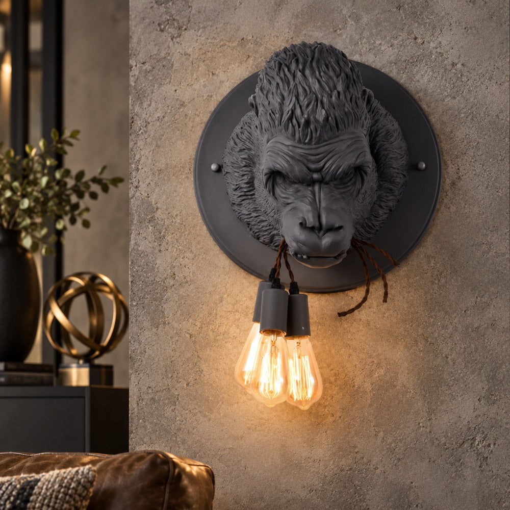Nordic Resin King Kong Gorilla Wall Lamp in black with two glowing Edison bulbs on a textured grey wall