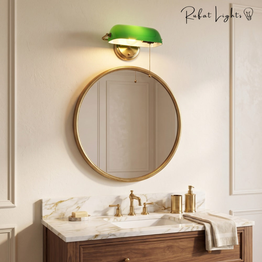 Industrial Vintage Green Banker Wall Lamp above a round mirror over a bathroom vanity