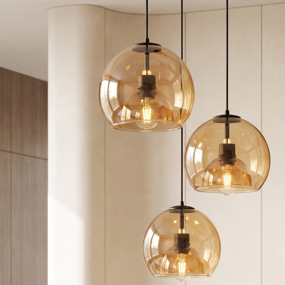 Modern Minimalist Glass Ceiling Light three amber glass globes hanging at staggered heights against a curved cream wall