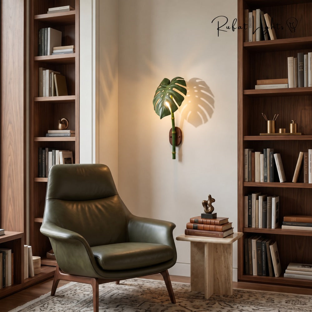 Monstera Leaf Bamboo Outdoor Wall Lamp beside an armchair in a reading corner