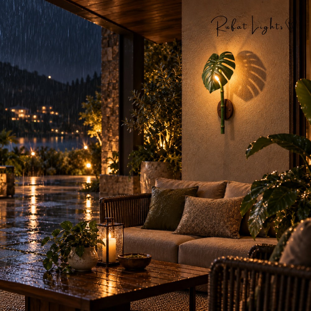 Monstera Leaf Bamboo Outdoor Wall Lamp on a covered patio at night