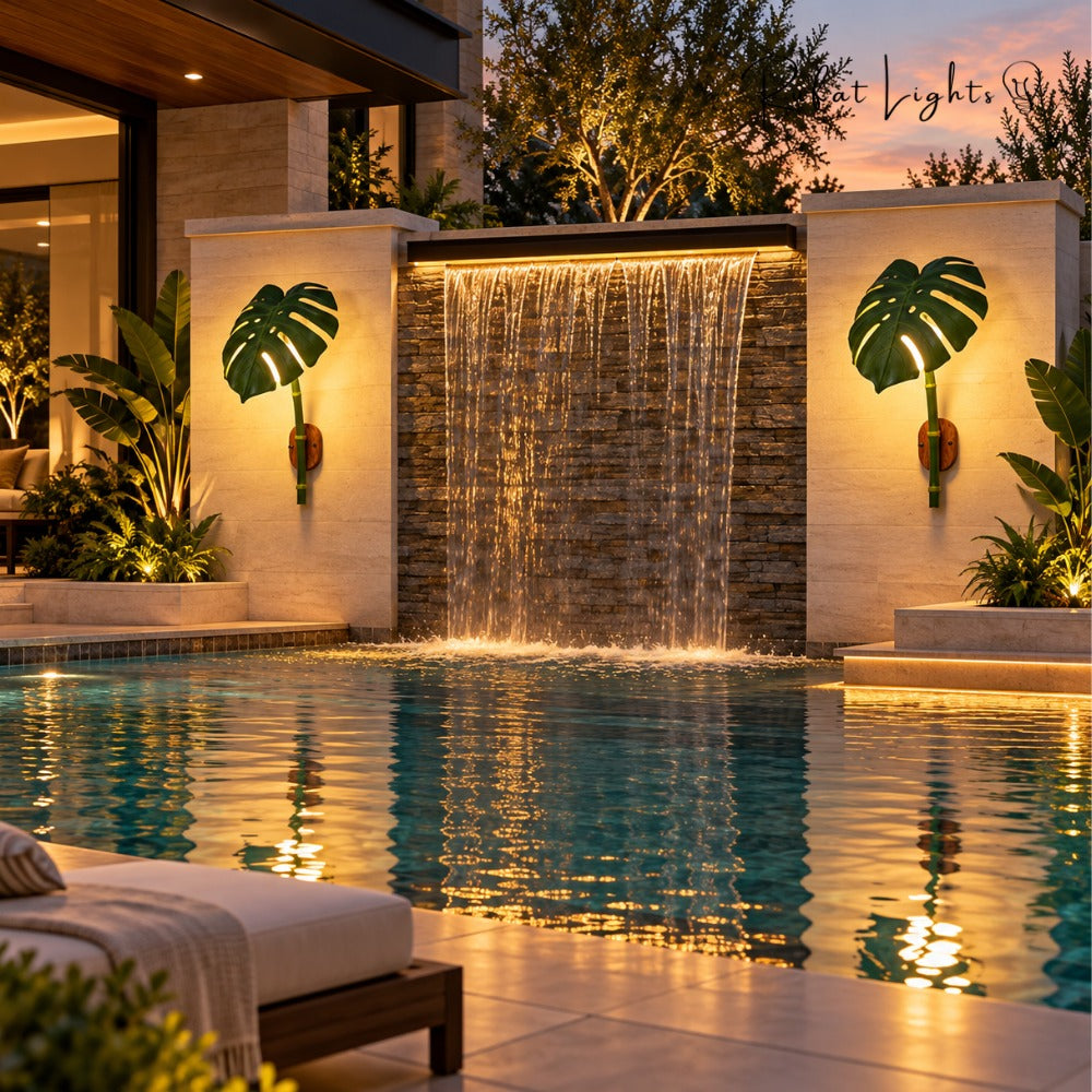 Monstera Leaf Bamboo Outdoor Wall Lamp pair beside a pool waterfall