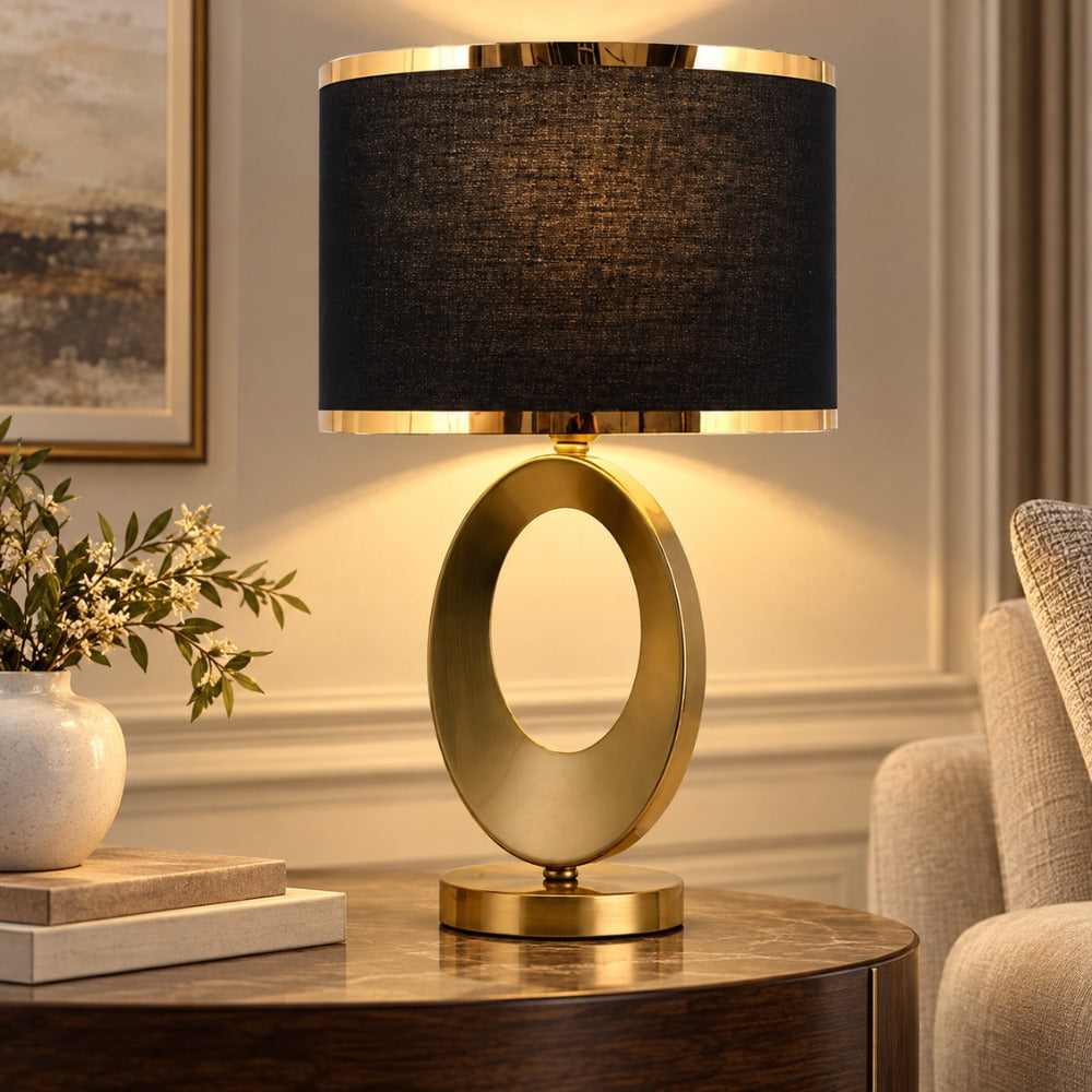 Nordic Luxury Cloth Covered Desk Lamp with black shade and gold ring base on a side table in a living room