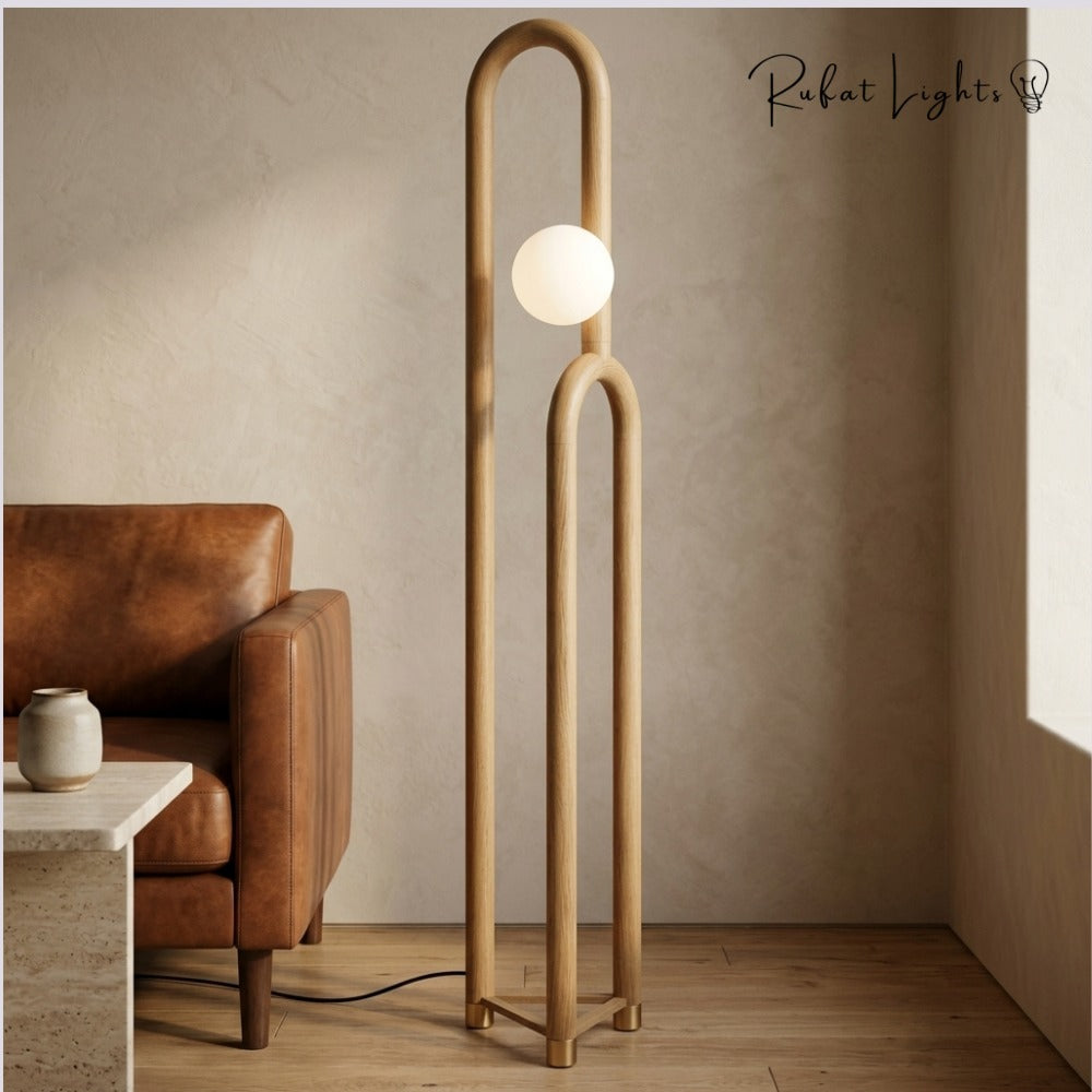 Nordic Wooden Floor Lamp light wood beside a leather armchair