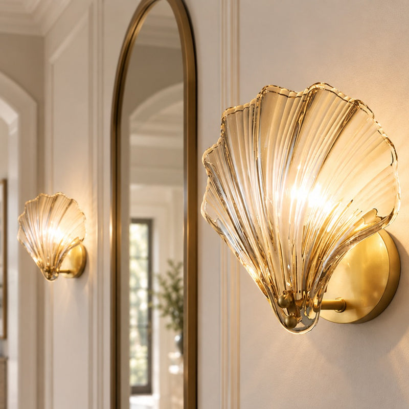 Oceanic Glass Shell Wall Light wall lights in amber glass beside an arched mirror