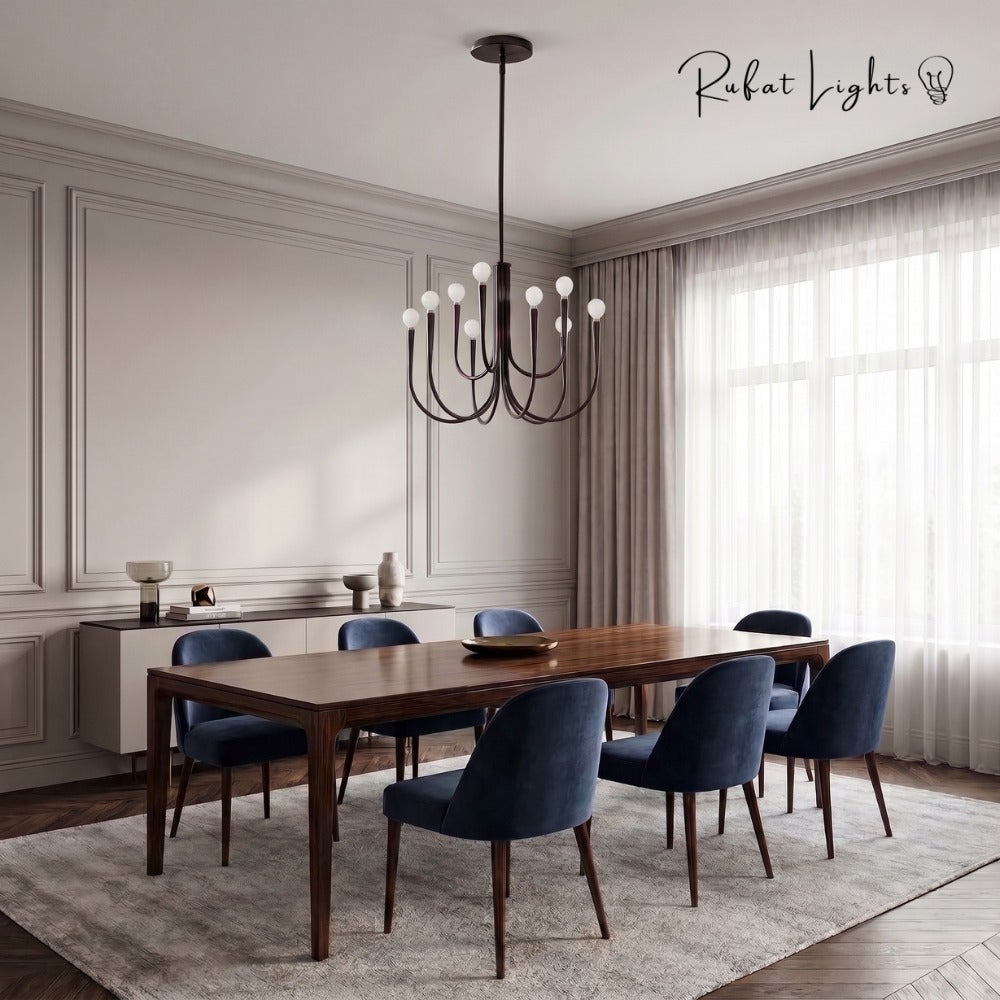 Retro Style Swoop Arm Luxury Chandelier Lamps in black above a dining table with navy velvet chairs
