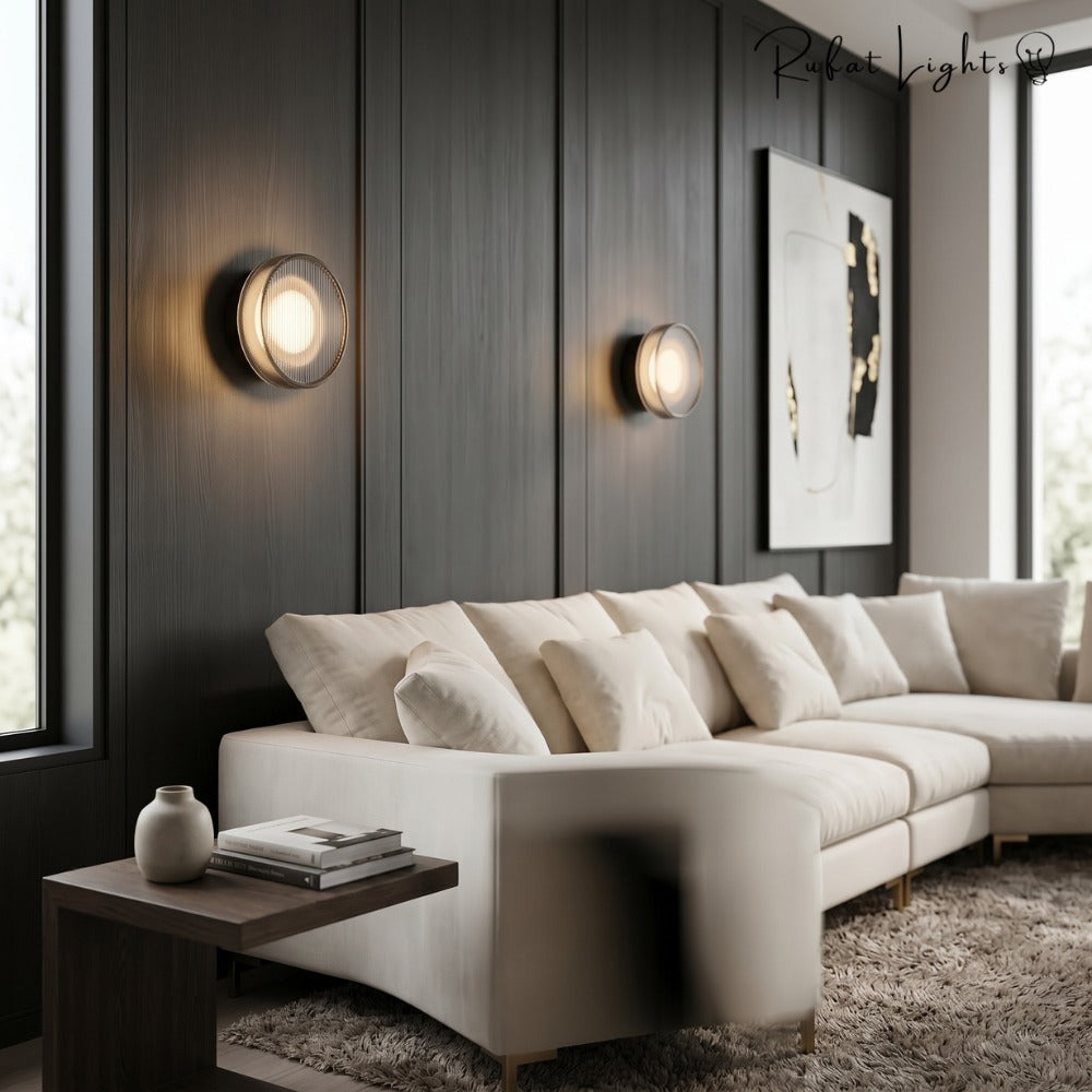 Round Textured Glass Wall Lamp in black pair above a white sectional sofa
