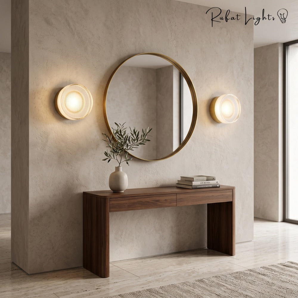 Round Textured Glass Wall Lamp in gold pair beside a round mirror in a foyer