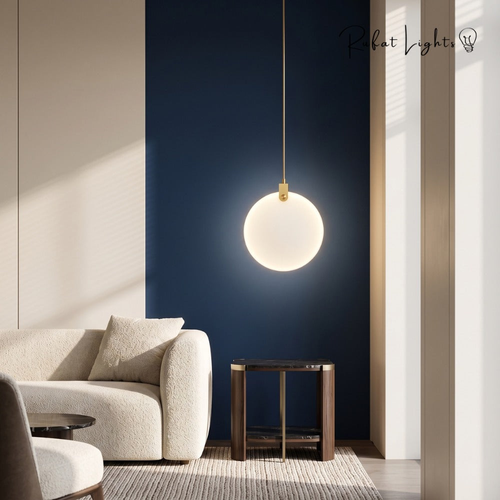 Simple Marble Round Crystal Villa Pendant Lamps beside an armchair