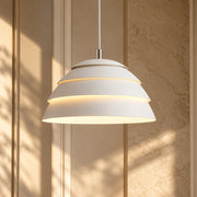 Single Head Iron Lamp Shade Pendant Light white tiered shade against a sunlit wall