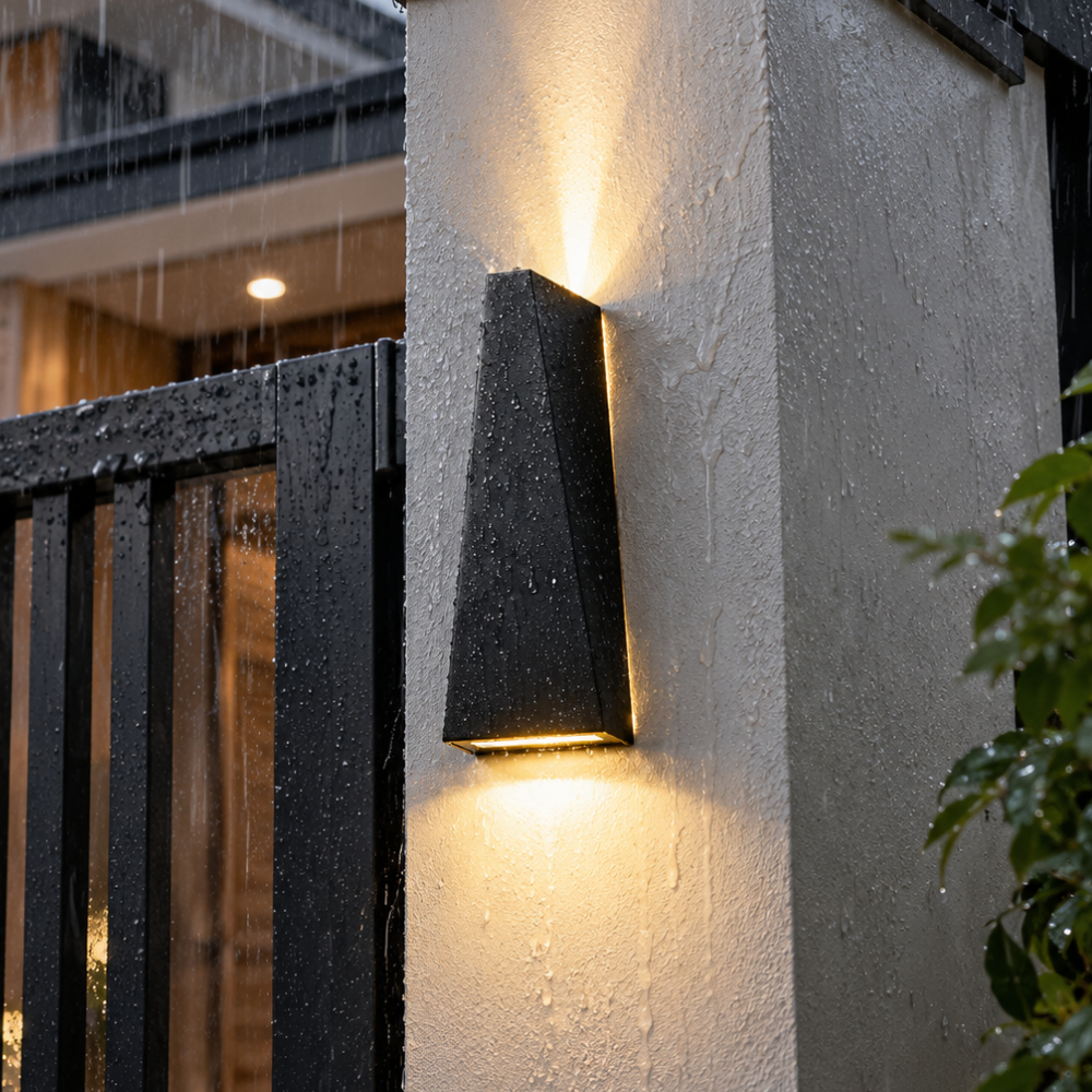 Sleek Waterproof Wall Lamp black up and down LED waterproof wall lamp glowing on a rain-wet outdoor wall
