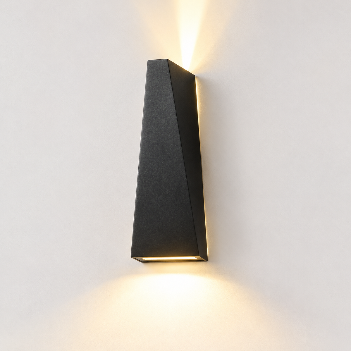 Sleek Waterproof Wall Lamp black up and down LED wall lamp glowing on a plain white wall