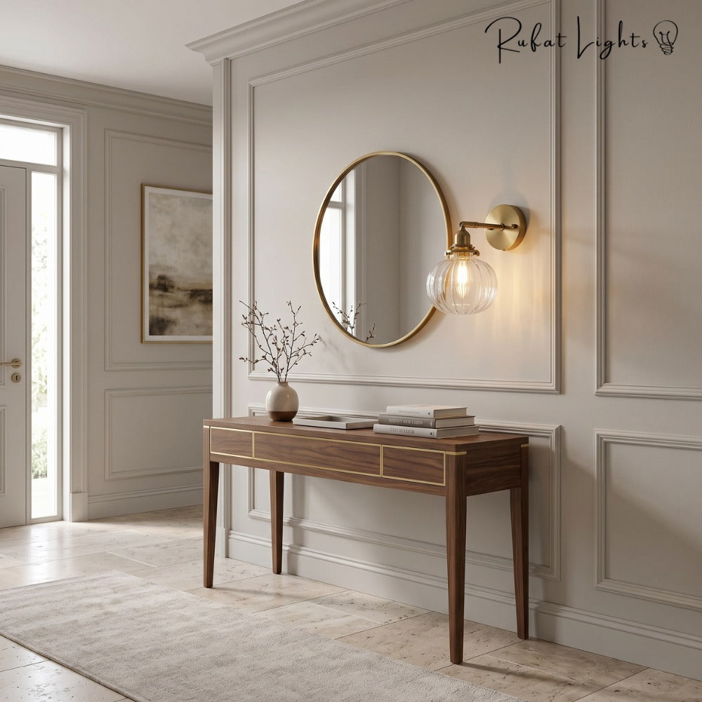 Textured Glass Globe Wall Lamp beside a round mirror above a console table