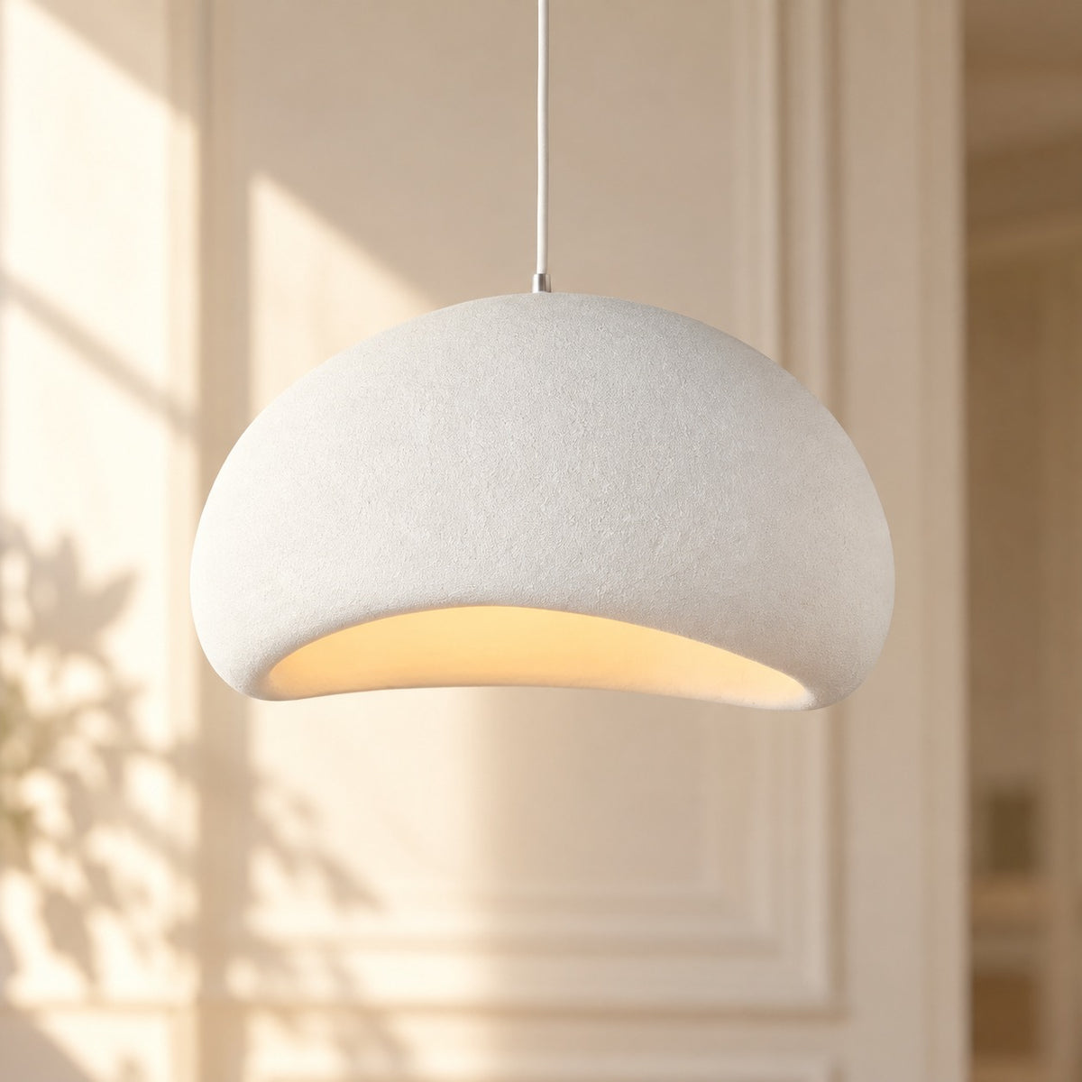 Wabi-Sabi Scandinavian Style Pendant Lights white shade against a paneled wall