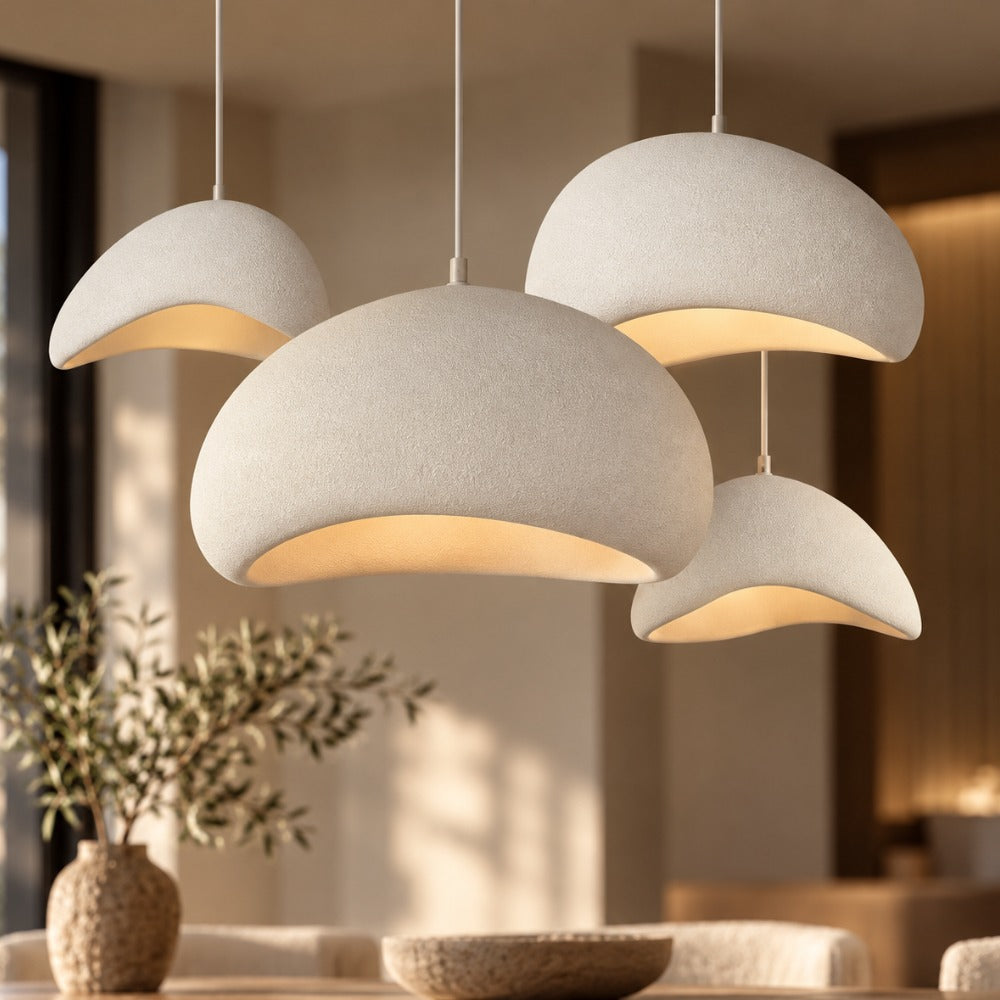 Wabi-Sabi Scandinavian Style Pendant Lights group of white shades above a dining table