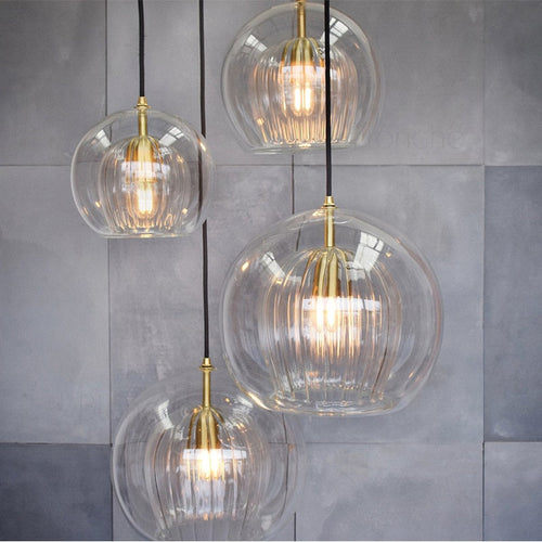 pendant light features a cocoon glass shade with a sleek metal frame