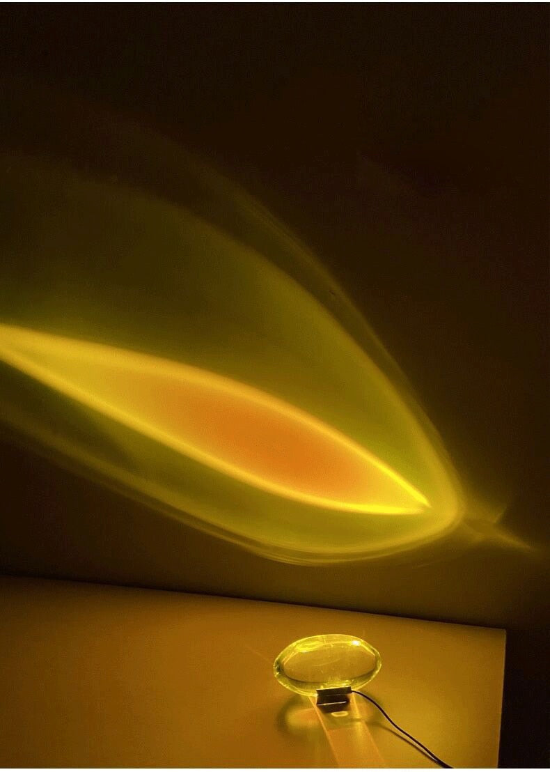 Mystical Radiance Crystal Sky Lamp in Sunset on a table casting an angled amber and orange light shape